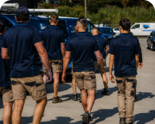 Plumbers walking to service vans